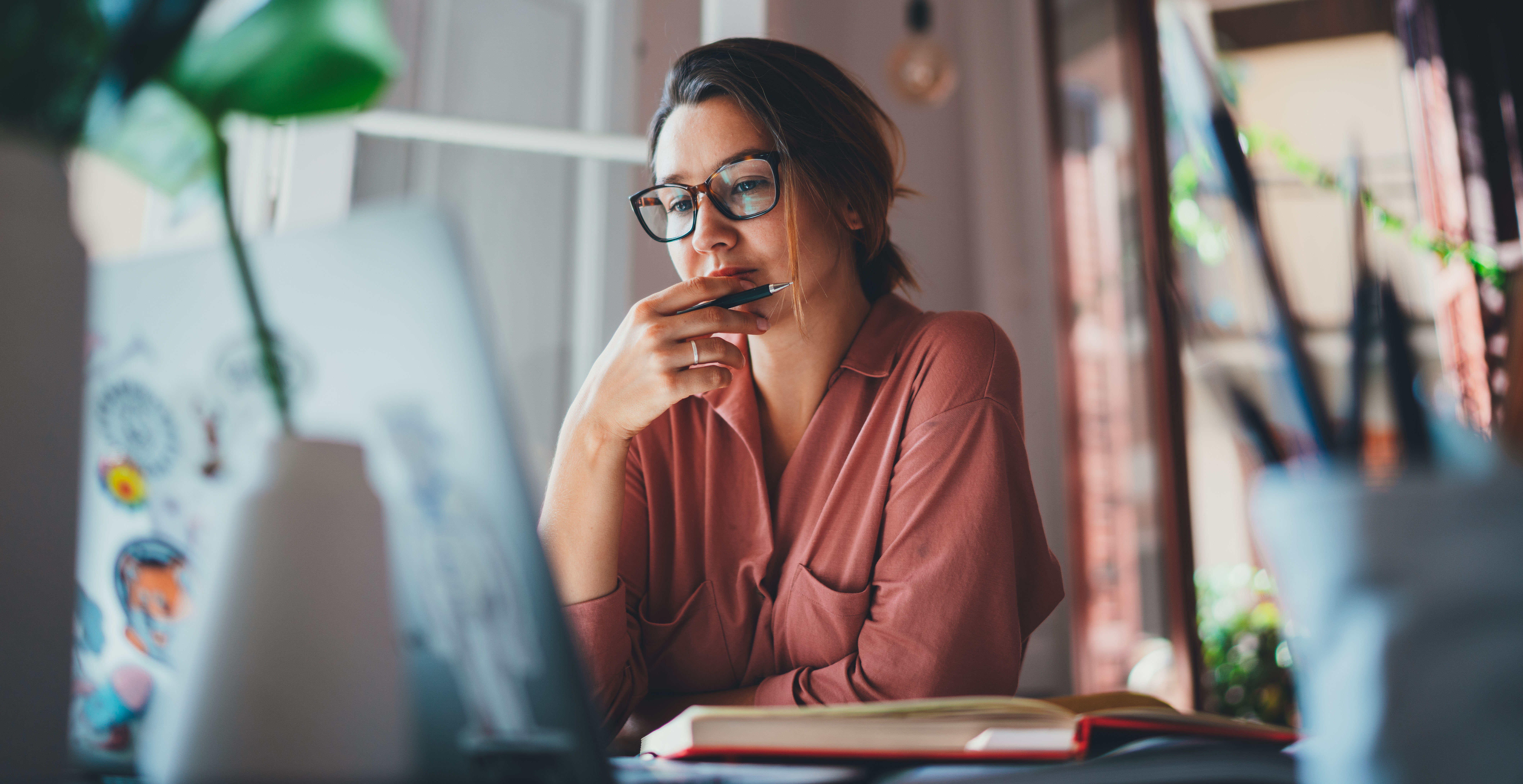 A young woman researches what she needs to open a checking account online.